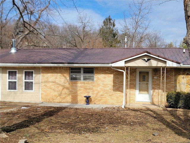 ranch-style house featuring brick siding