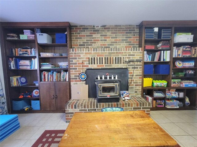 tiled living room featuring a wood stove