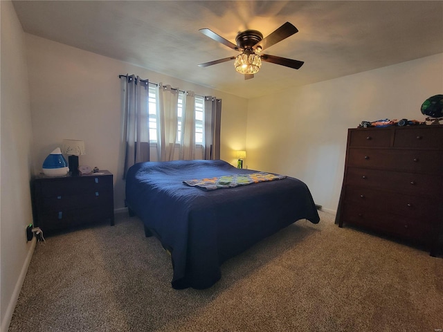 bedroom featuring a ceiling fan, carpet flooring, and baseboards