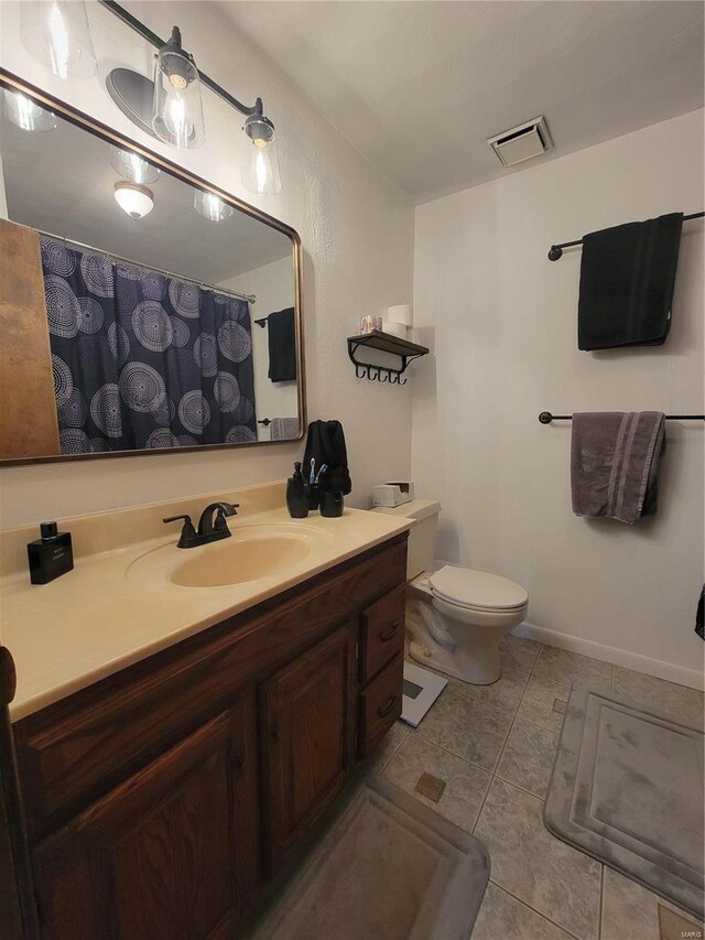 bathroom with visible vents, toilet, curtained shower, tile patterned flooring, and vanity