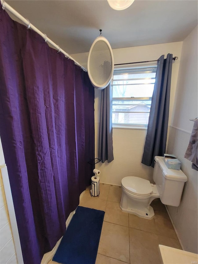 bathroom with toilet and tile patterned floors