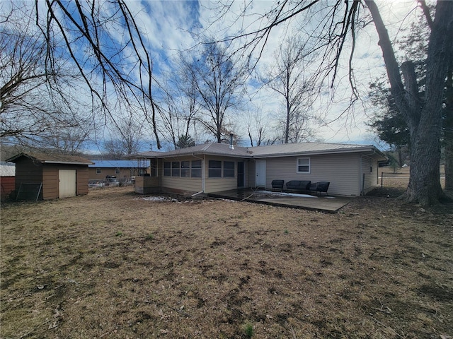 rear view of property with a lawn, a patio area, fence, a shed, and an outdoor structure