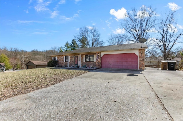 ranch-style house featuring a garage, concrete driveway, and brick siding