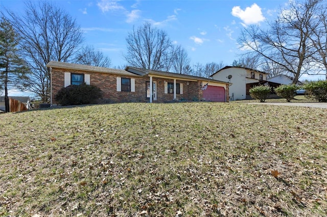 ranch-style house with a garage, a front yard, and brick siding