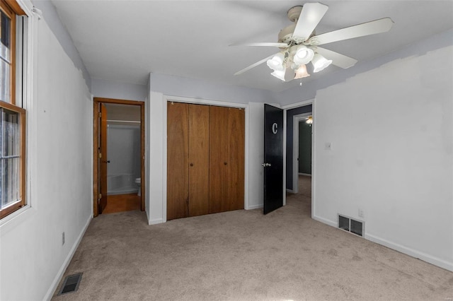 unfurnished bedroom featuring carpet, visible vents, and baseboards