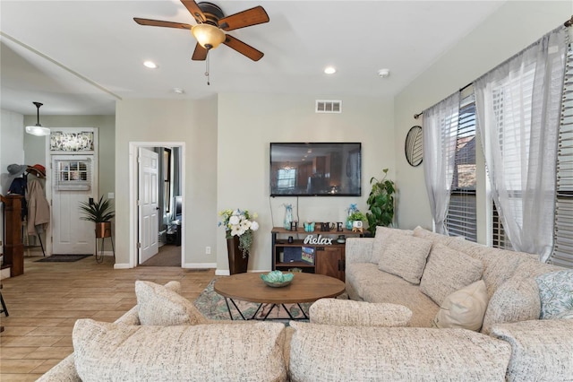 living area featuring visible vents, recessed lighting, light wood-style flooring, and baseboards