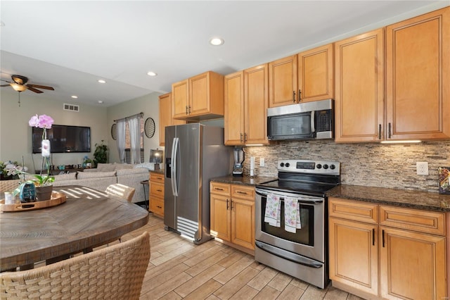 kitchen with light wood-style flooring, recessed lighting, decorative backsplash, appliances with stainless steel finishes, and open floor plan