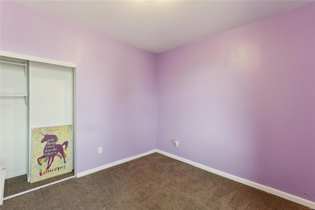 unfurnished bedroom with a closet, baseboards, and carpet