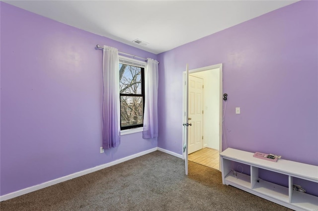 unfurnished bedroom featuring carpet flooring, baseboards, and visible vents