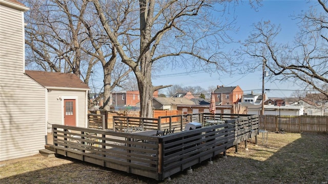 view of yard with a wooden deck, a residential view, and a fenced backyard