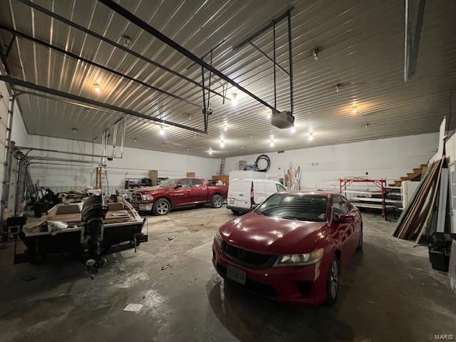 garage with metal wall and a garage door opener