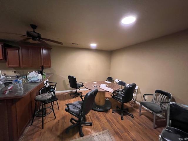 home office featuring baseboards, wood finished floors, and recessed lighting