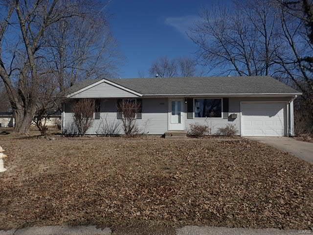 ranch-style house with an attached garage, driveway, and brick siding