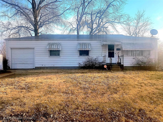 single story home with a garage and a front lawn