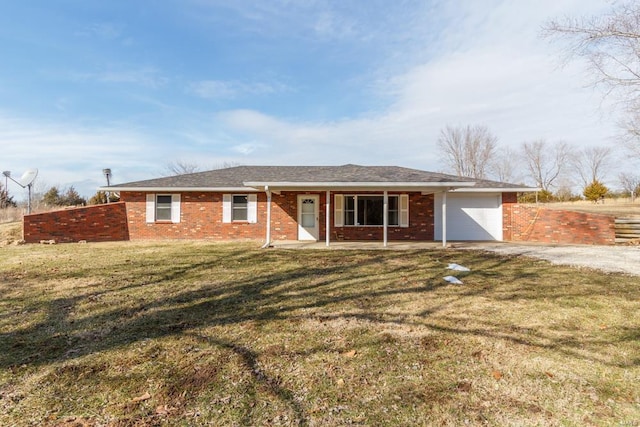 ranch-style home featuring an attached garage, driveway, a front lawn, and brick siding