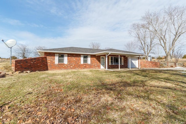 single story home featuring an attached garage, fence, a front lawn, and brick siding