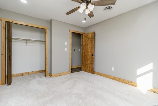 unfurnished bedroom with carpet floors, visible vents, baseboards, and a closet