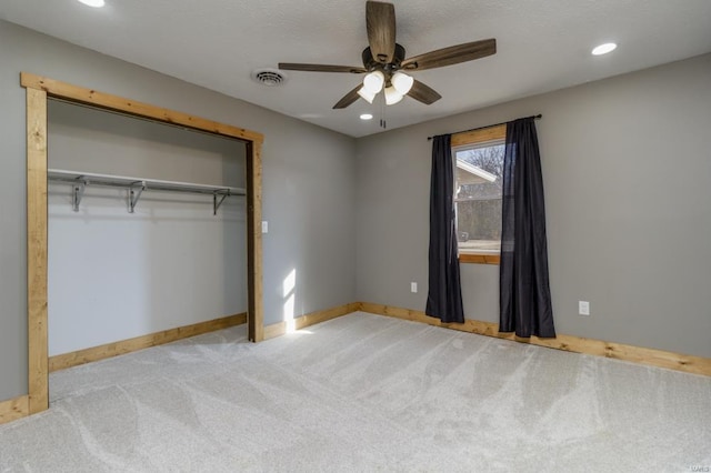 unfurnished bedroom with baseboards, a closet, visible vents, and carpet flooring