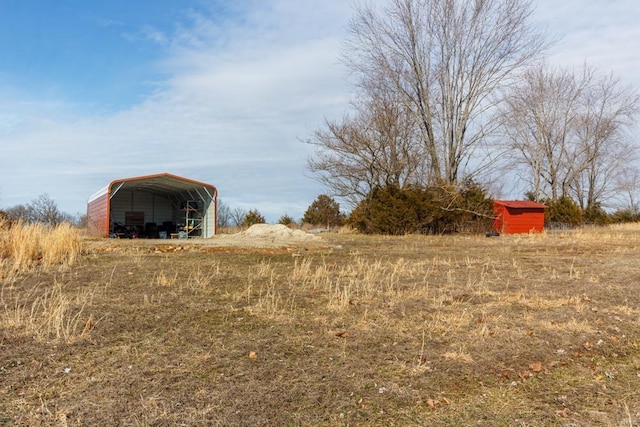 view of yard featuring an outbuilding and a carport