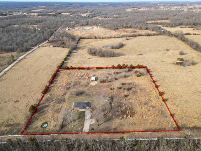 birds eye view of property with a rural view