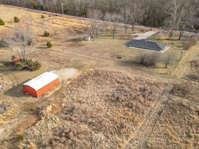 birds eye view of property with a rural view