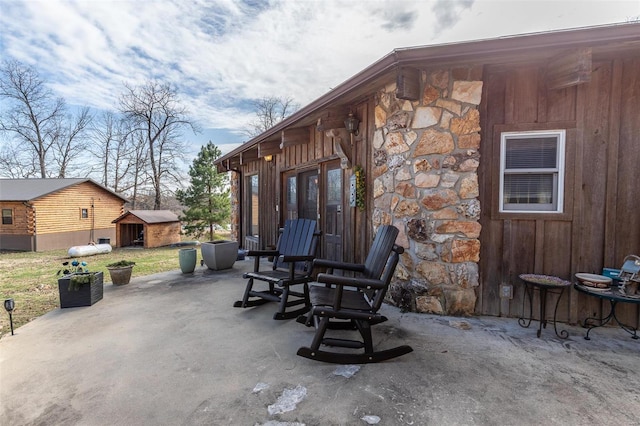 view of patio featuring an outdoor structure and a storage shed