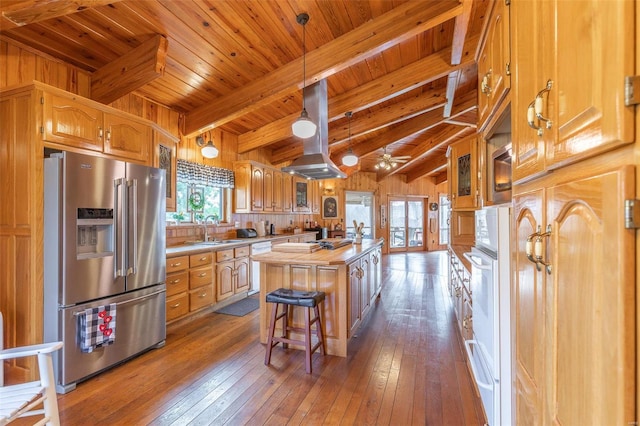 kitchen with butcher block counters, a kitchen island, a sink, island range hood, and white appliances