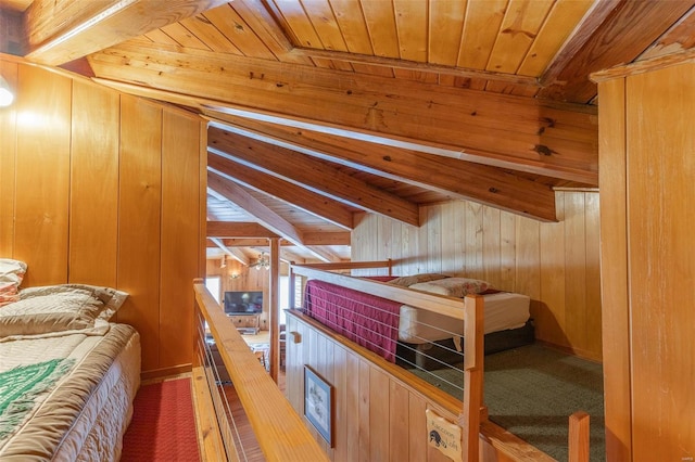 bedroom featuring wooden ceiling, beam ceiling, and wooden walls