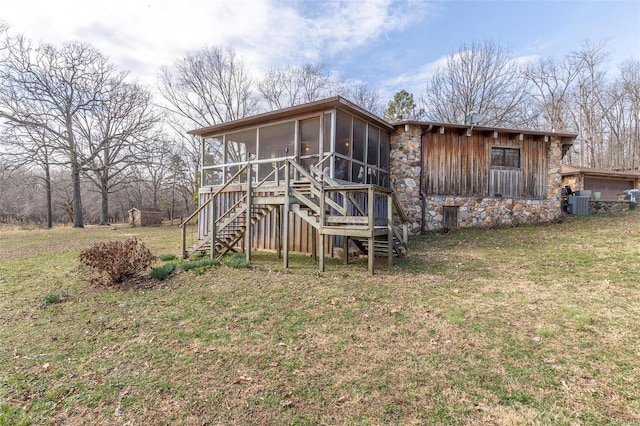 back of house featuring a sunroom, stairs, central AC unit, and a yard