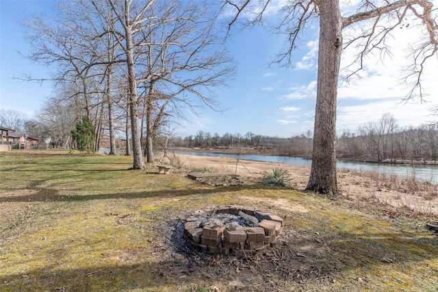 view of yard featuring an outdoor fire pit and a water view