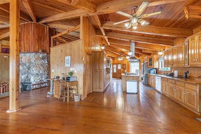 kitchen with white dishwasher, wooden walls, ventilation hood, and hardwood / wood-style flooring