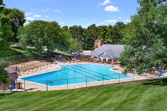 pool featuring a yard and fence