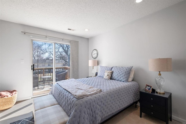 bedroom with access to exterior, a textured ceiling, visible vents, and carpet flooring