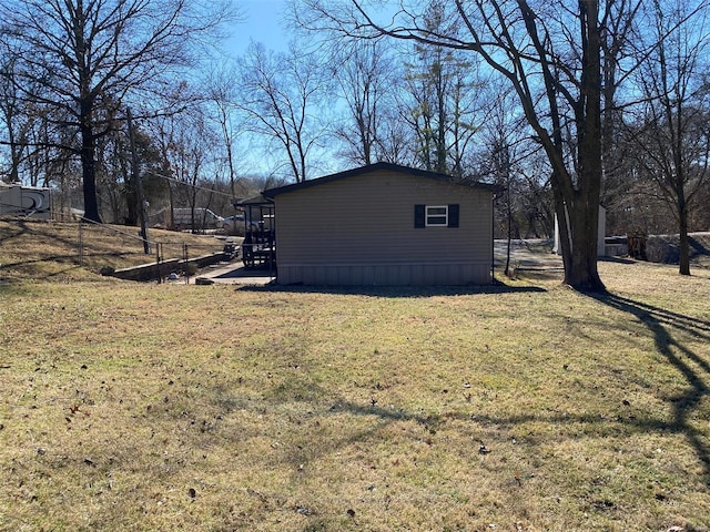 view of side of home with a yard