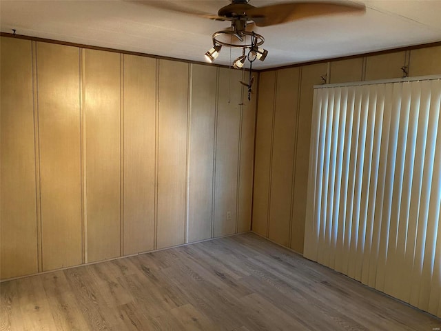 unfurnished room featuring a ceiling fan and light wood-type flooring