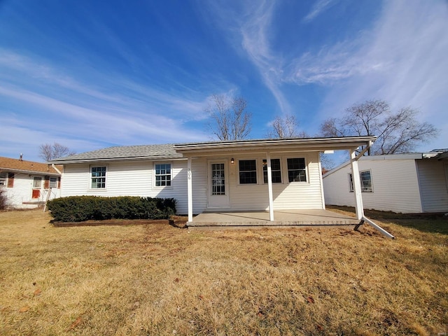 rear view of house featuring a yard and a patio