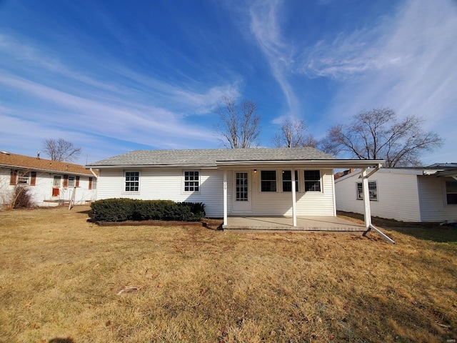 back of house featuring a yard and a patio area