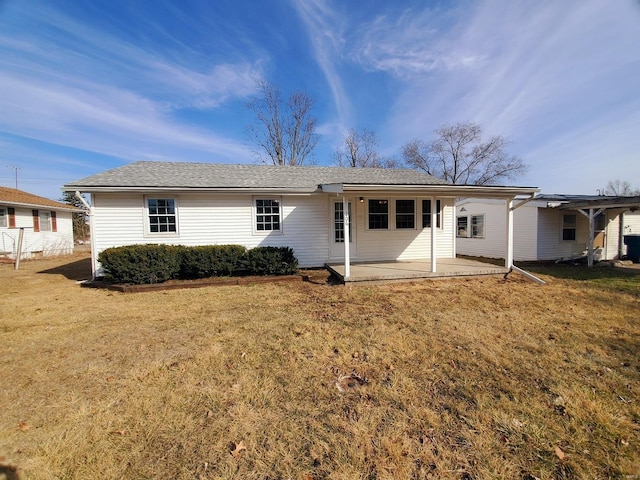 rear view of house featuring a patio and a lawn