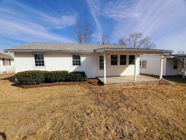 back of house with a patio area and a yard