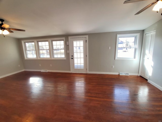 spare room with visible vents, a wealth of natural light, and wood finished floors