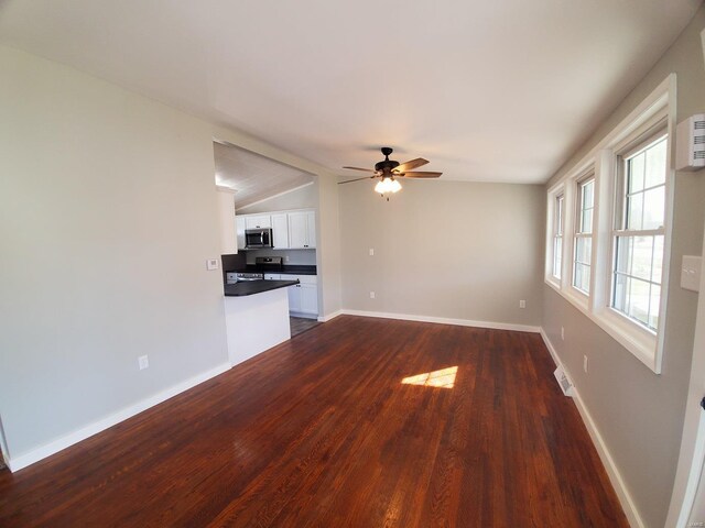 unfurnished living room featuring lofted ceiling, visible vents, baseboards, and dark wood-style flooring