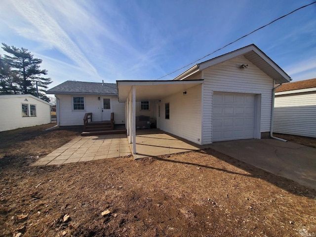 exterior space featuring a garage and concrete driveway