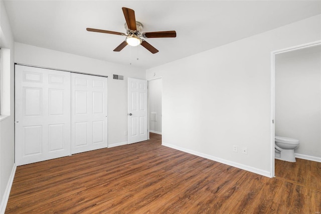 unfurnished bedroom featuring visible vents, a closet, baseboards, and wood finished floors