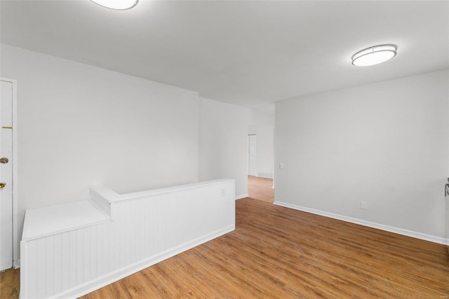 empty room featuring wood finished floors and baseboards