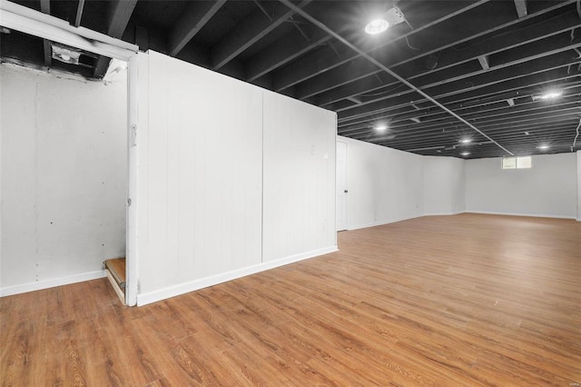 basement featuring wood finished floors and baseboards