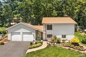 view of front of home featuring aphalt driveway and an attached garage