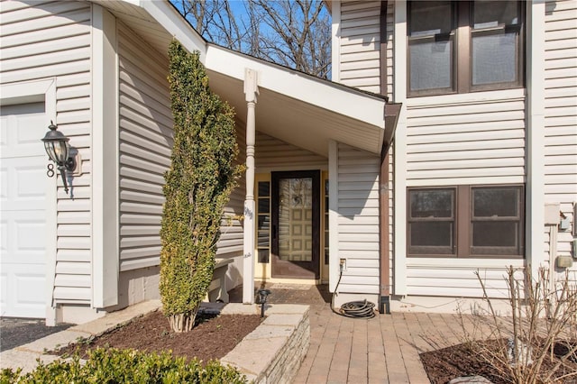 doorway to property featuring an attached garage