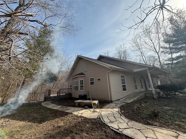 view of home's exterior featuring a wooden deck