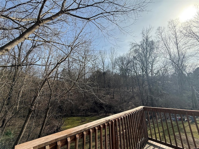 wooden deck featuring a view of trees