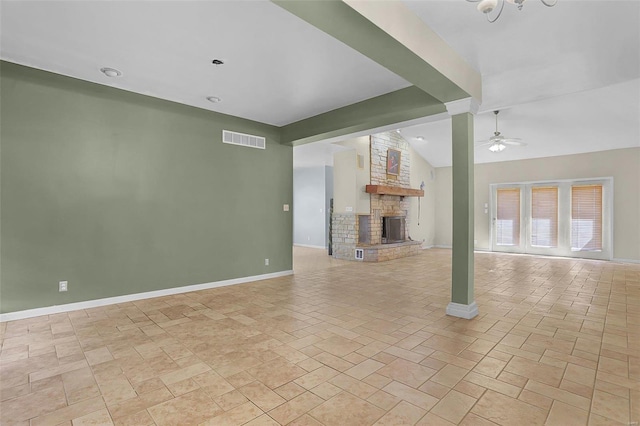 unfurnished living room with baseboards, visible vents, vaulted ceiling with beams, ceiling fan, and a large fireplace